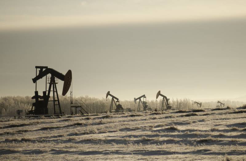 1707271380 field with oil pump jacks surrounded by greenery cloudy sky sunlight